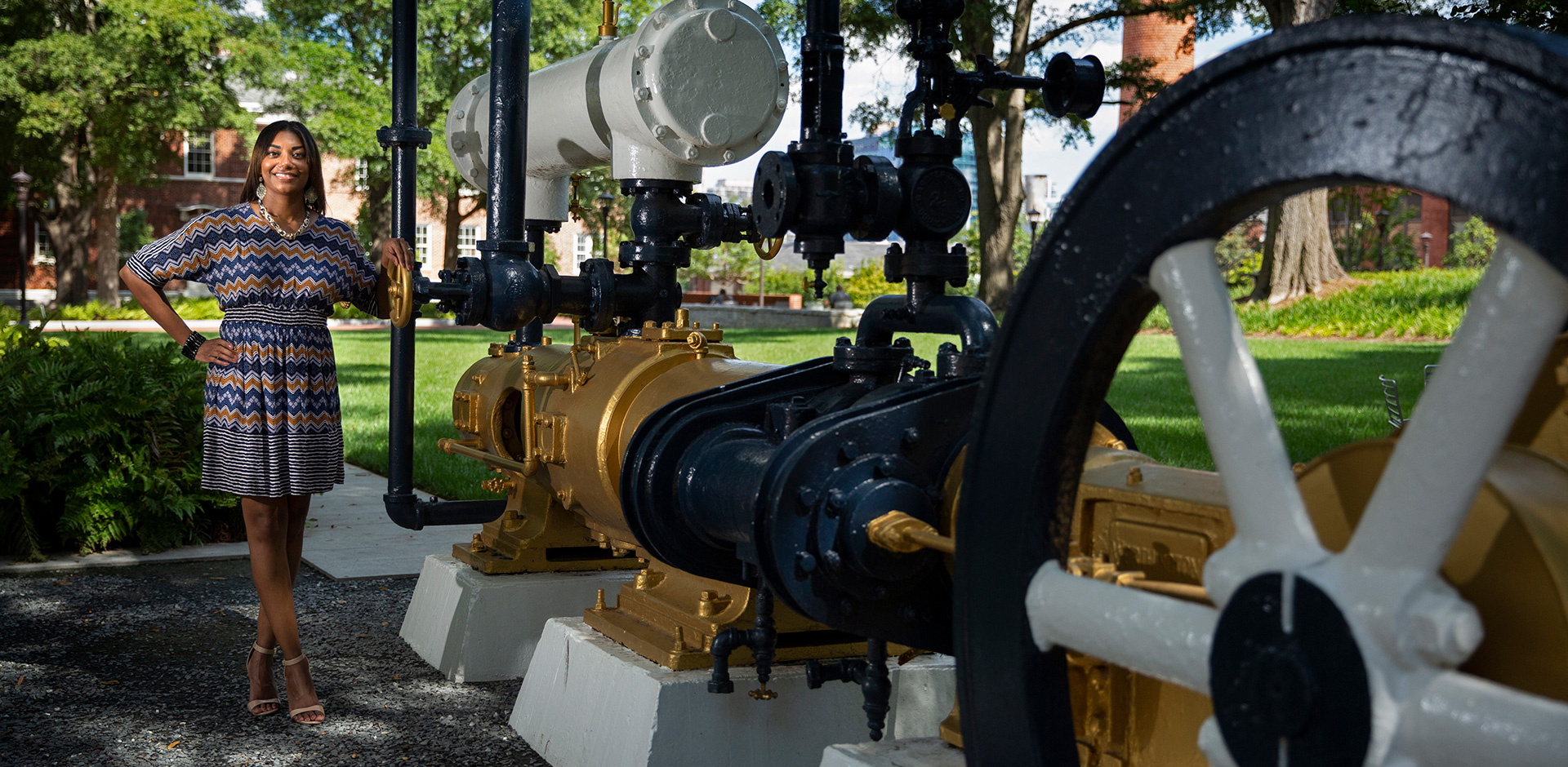 photo: Michelle Gowdy standing in front of iconic Georgia Tech steam engine