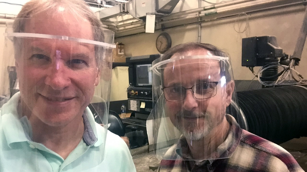 photo: GTRI employees Dennis Denney (left) and Jeff Wilkie (right) are wearing face shield prototypes developed by GTRI.