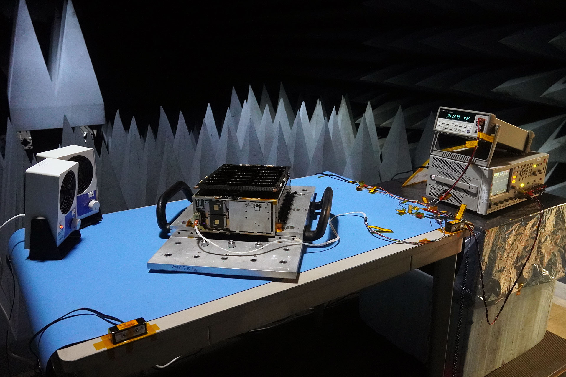 Device sitting on table in testing chamber.