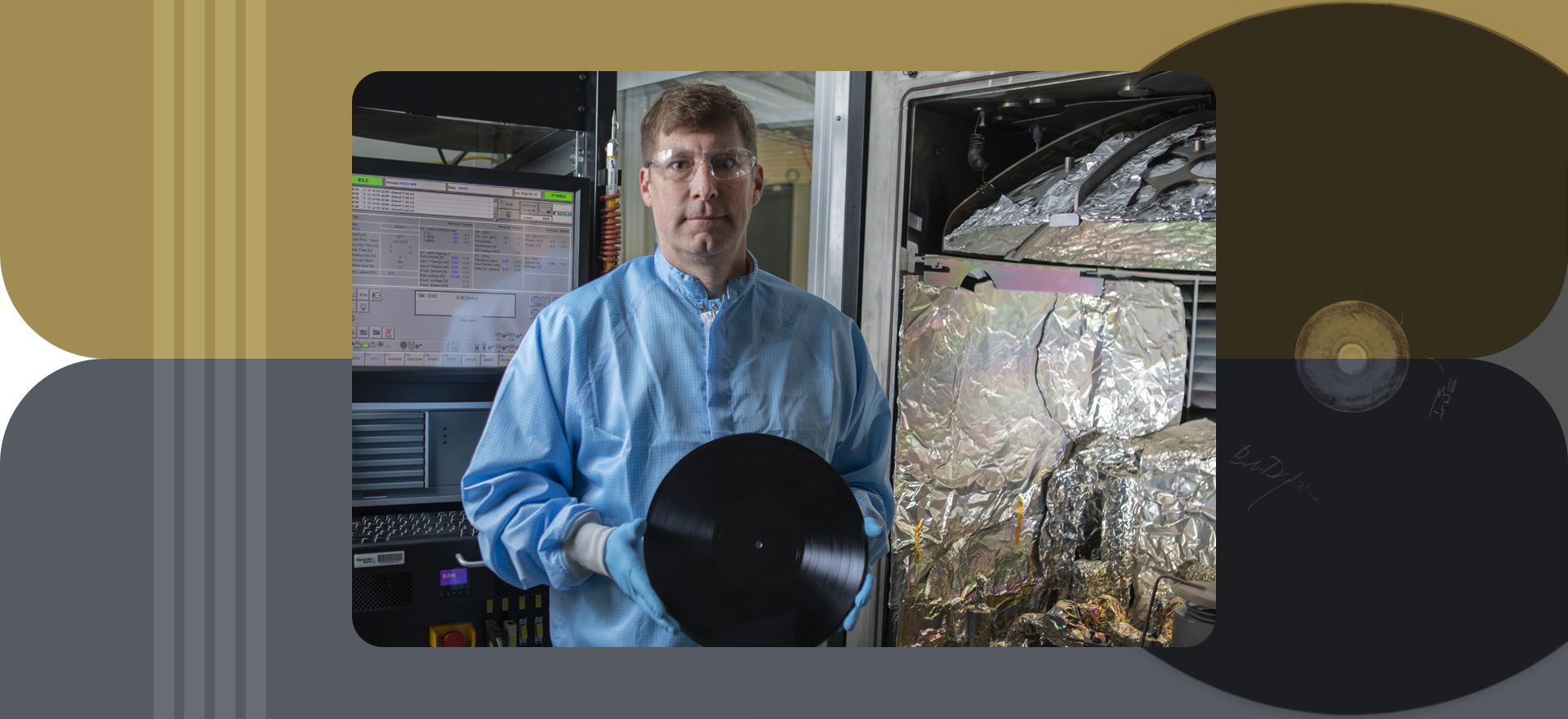 Researcher in clean room, dressed in full protective gear holds disc