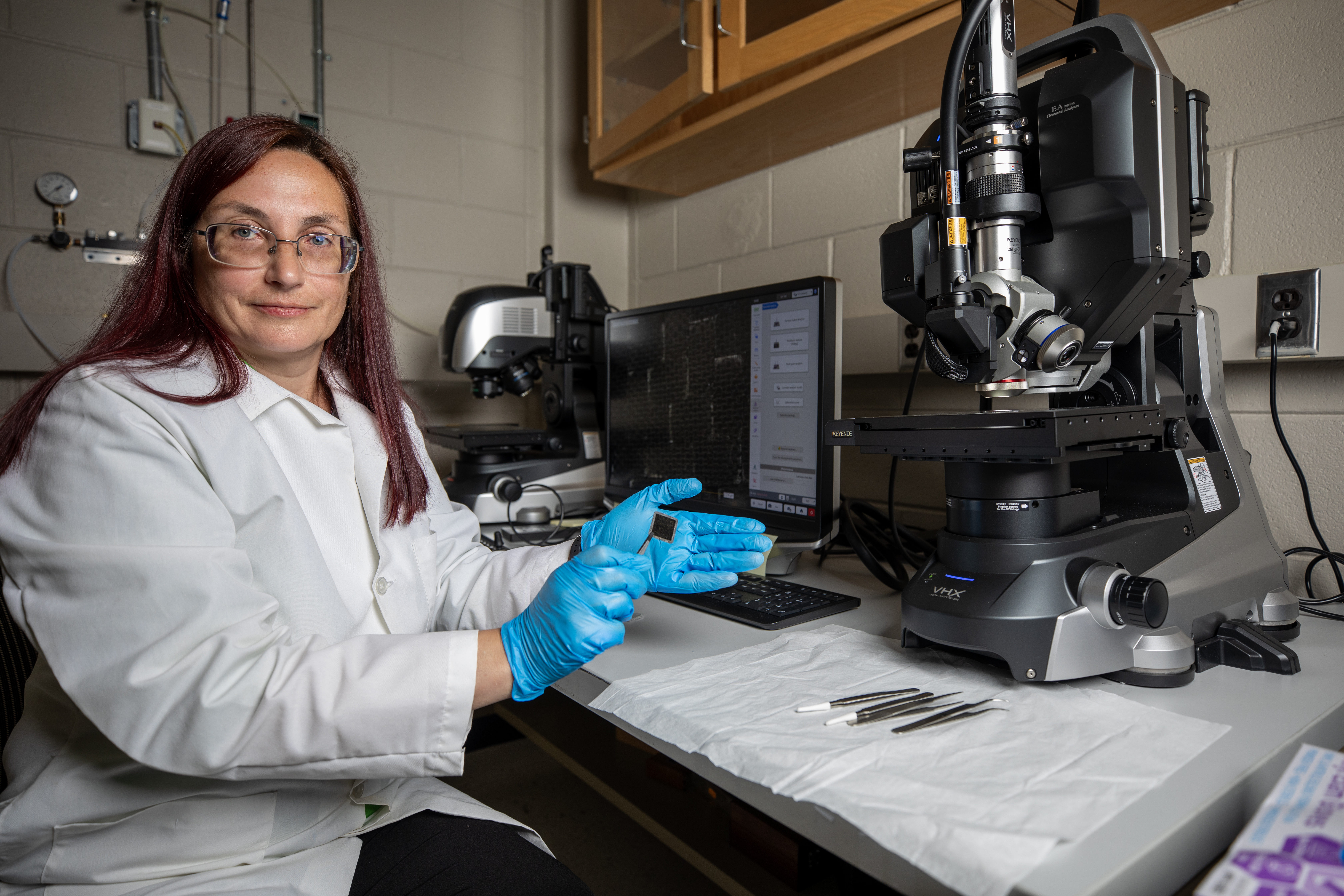 GTRI senior research engineer Elena Plis prepares to analyze a material sample that had been exposed to the space environment on the outside the International Space Station