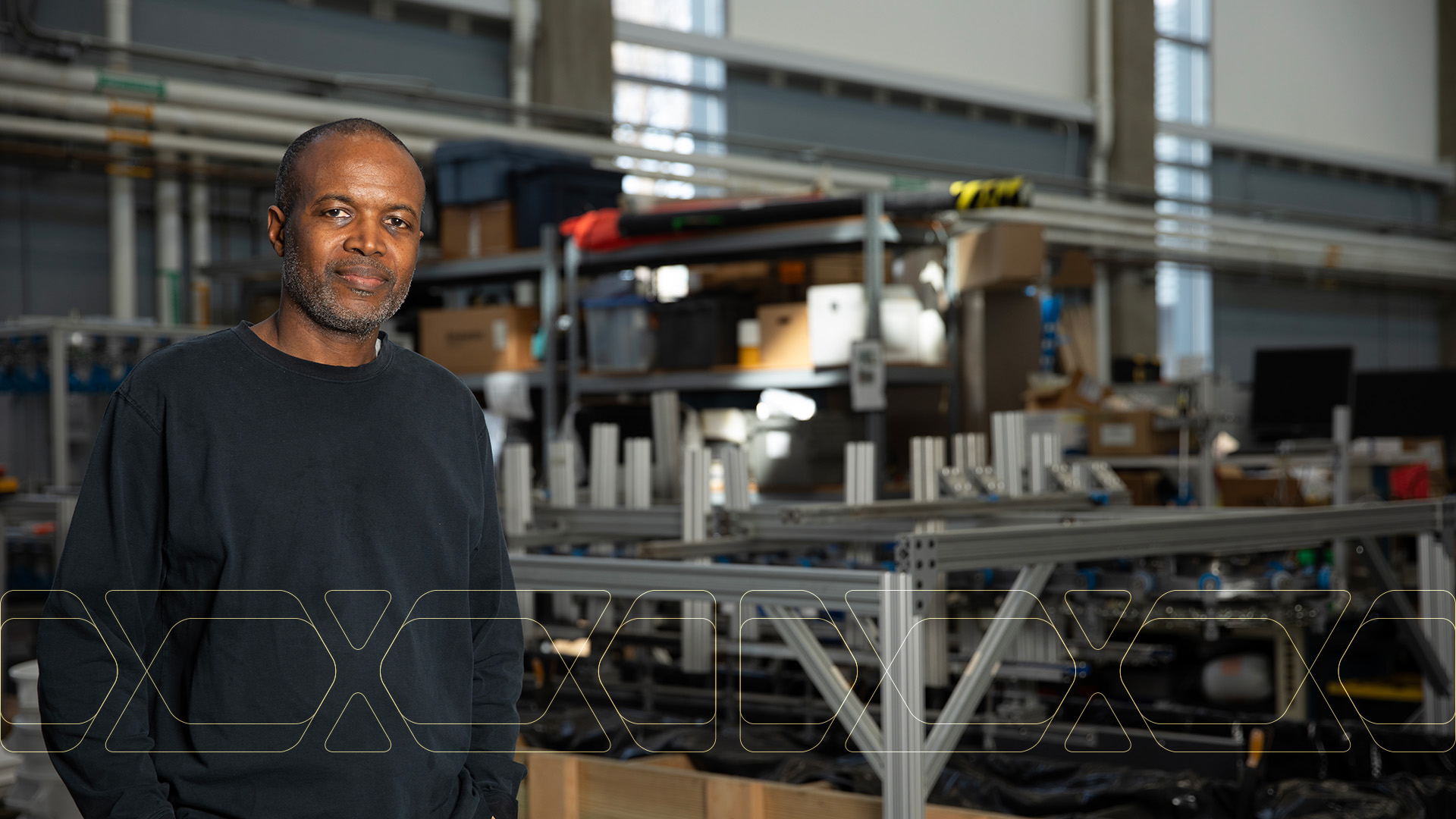 Comas Haynes standing inside a research facility with equipment in background.