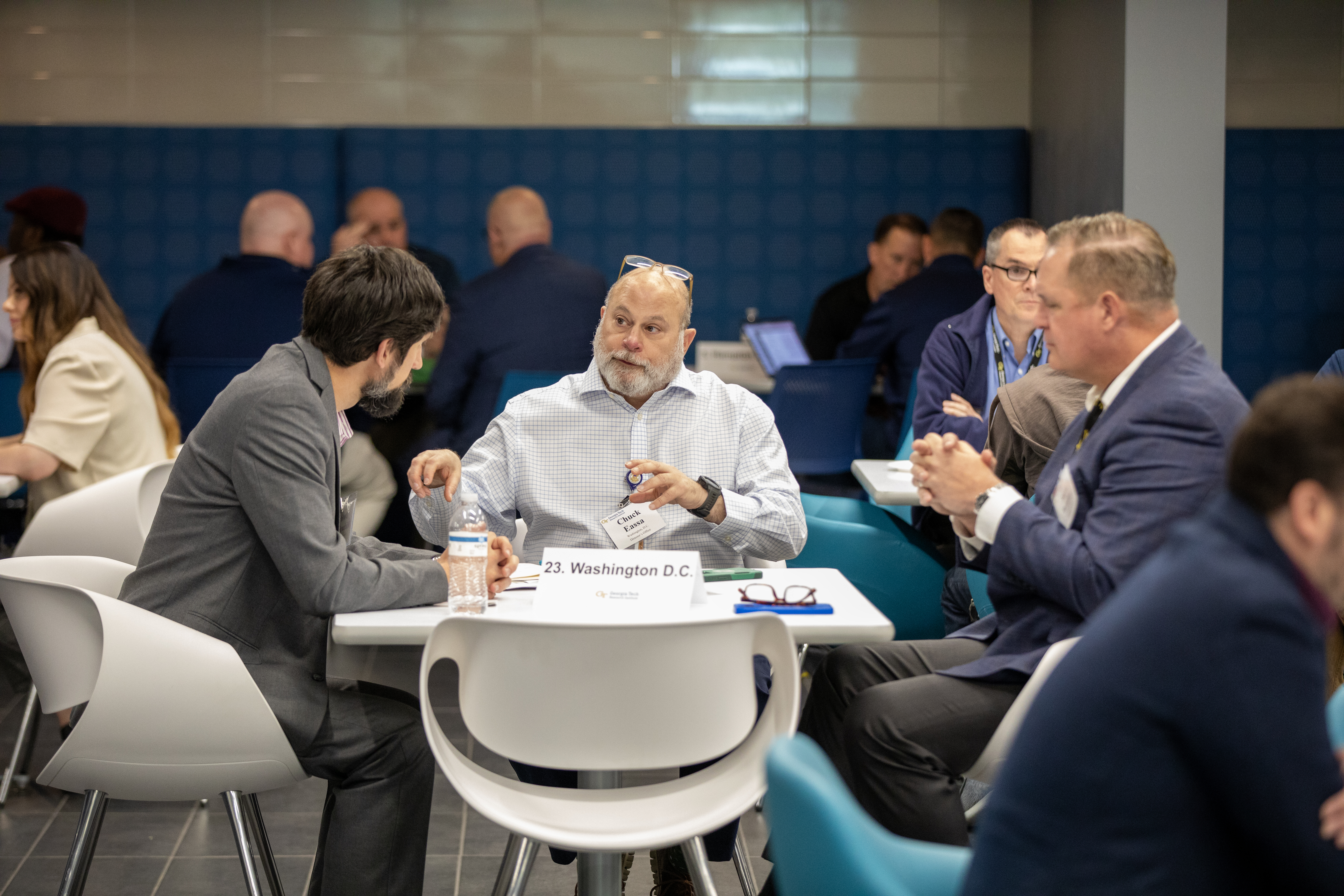 three men at a table discussing research
