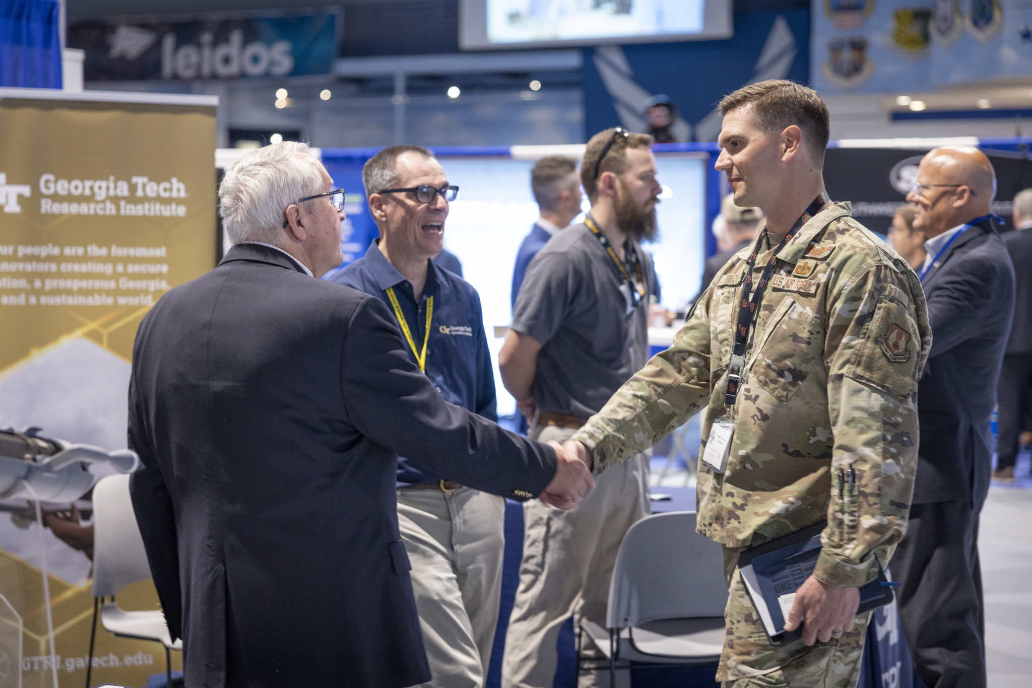 At Dixie Crow Symposium, Douglas Nation and Lee Evans greet a serviceman. (Photo Credit: Christopher J. Moore, GTRI)