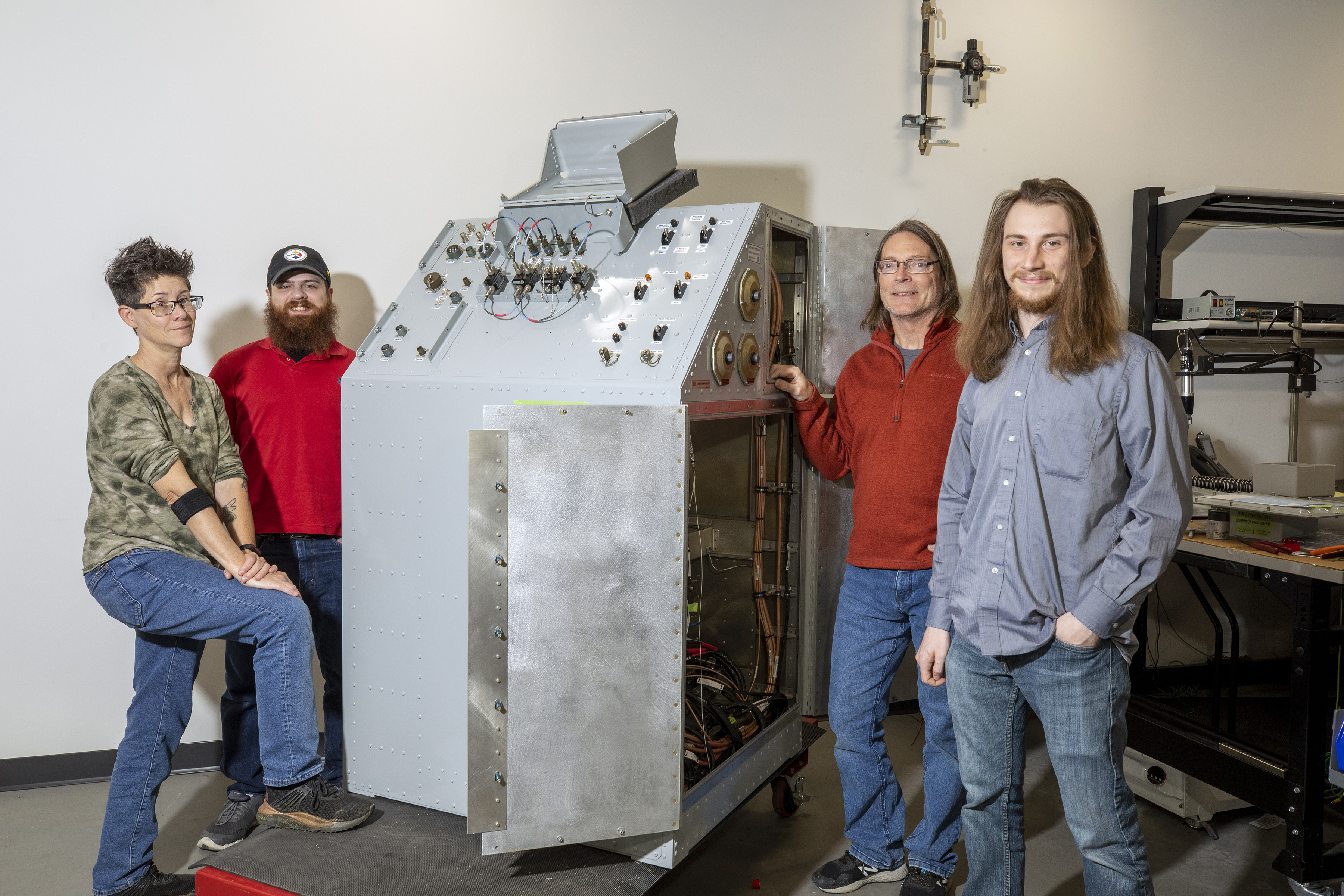 GTRI technicians with an E-3G equipment cabinet