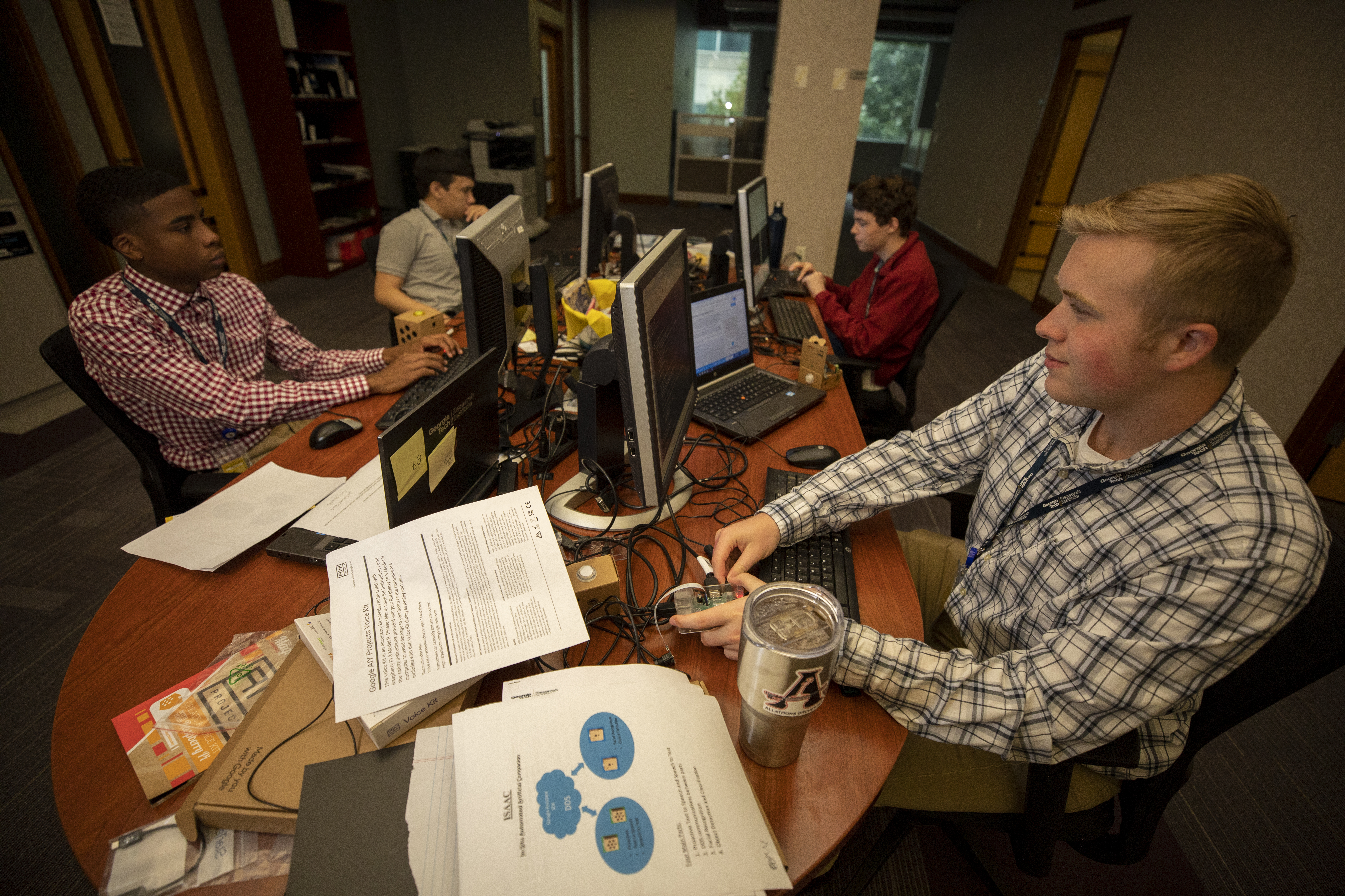 All four interns are hard a work, coding and assisting one another to ensure the success of the Senior In-Home Artificial Intelligence Assistant project. (Photo: Sean McNeil, Georgia Tech Research Institute)