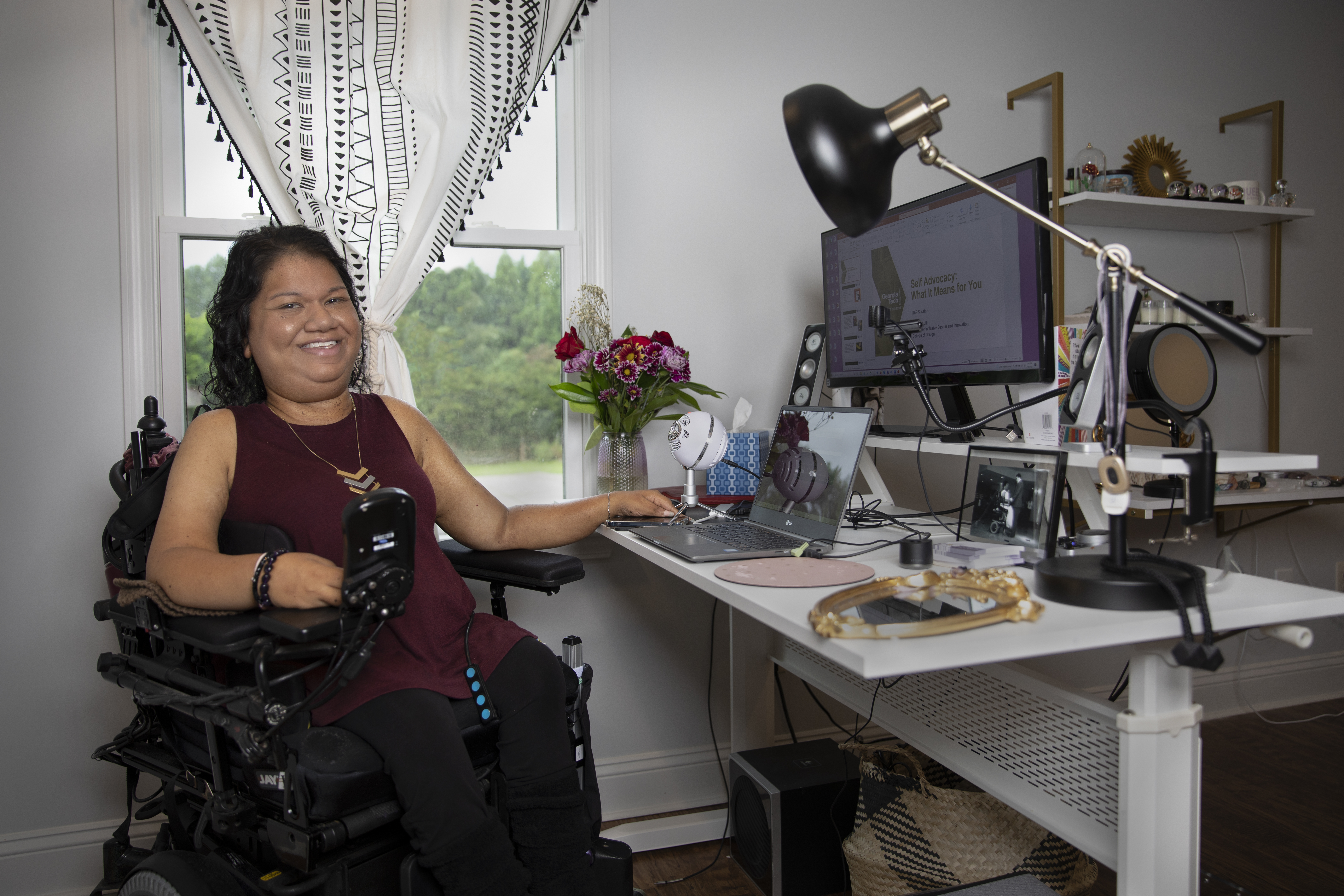 Liz Persaud sits at her desk at home