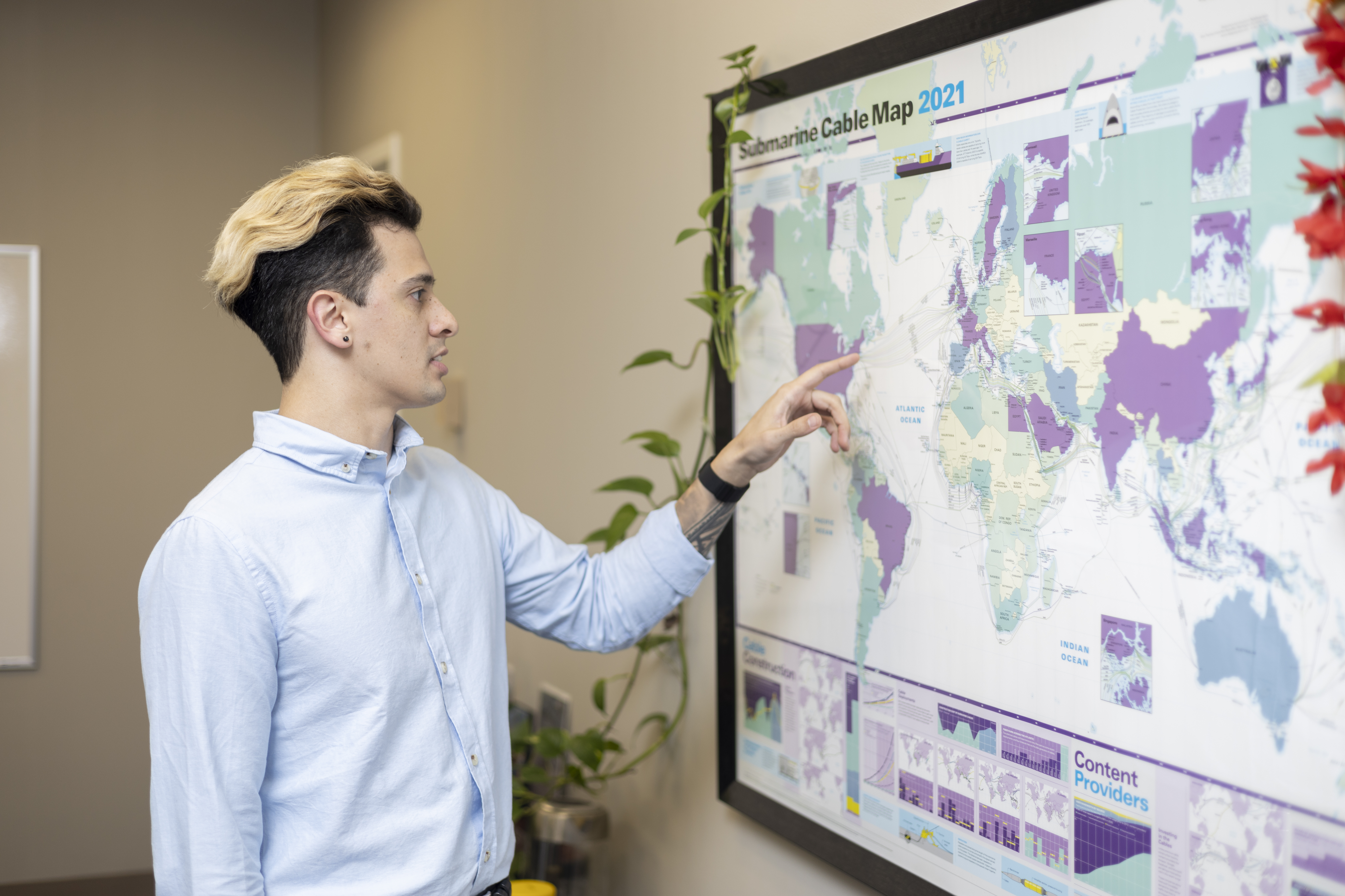 Moi standing and pointing at a submarine cable map.