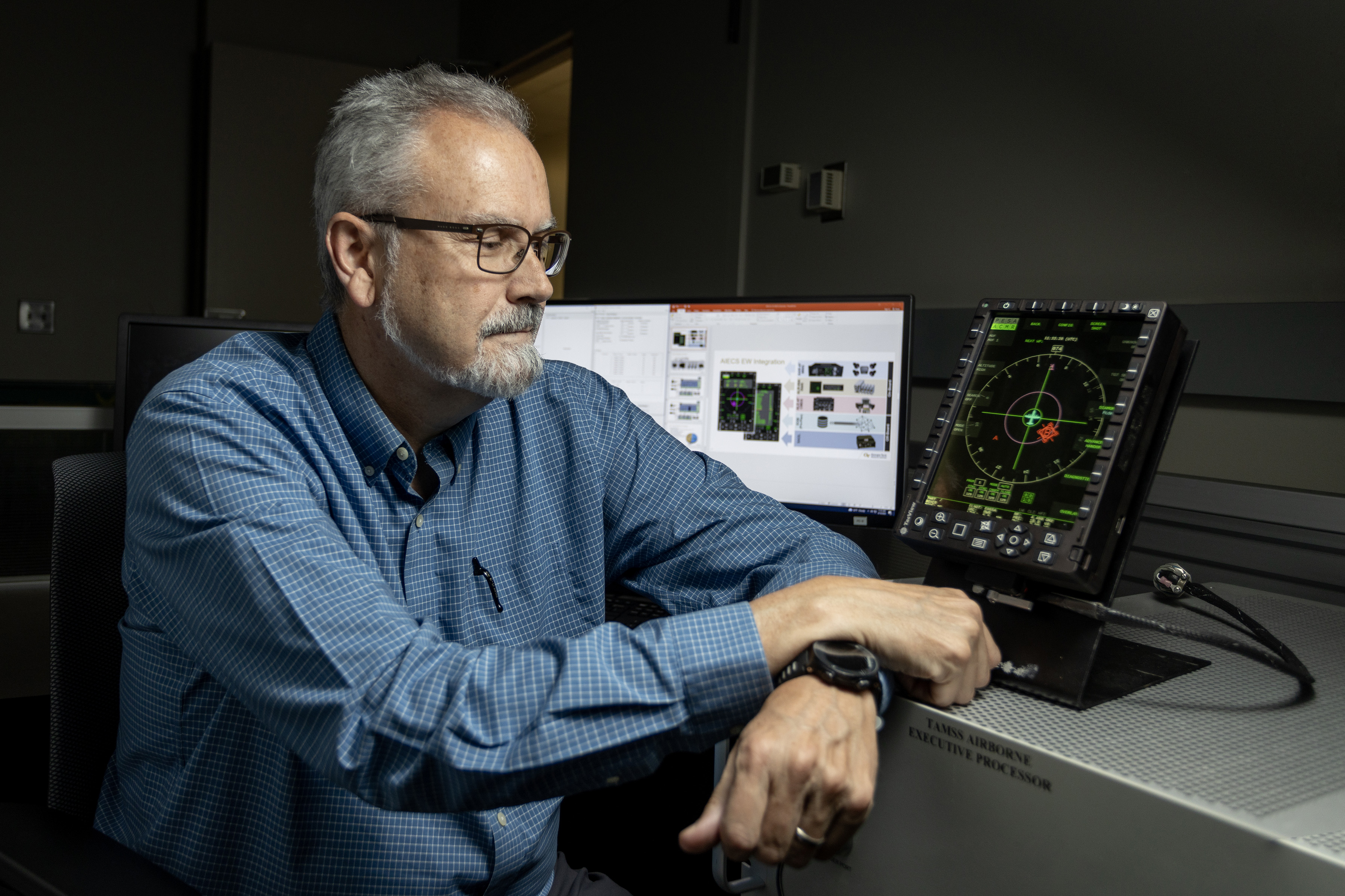 Dan LaGesse with aircraft display for the Advanced Integrated Electronic Combat Suite