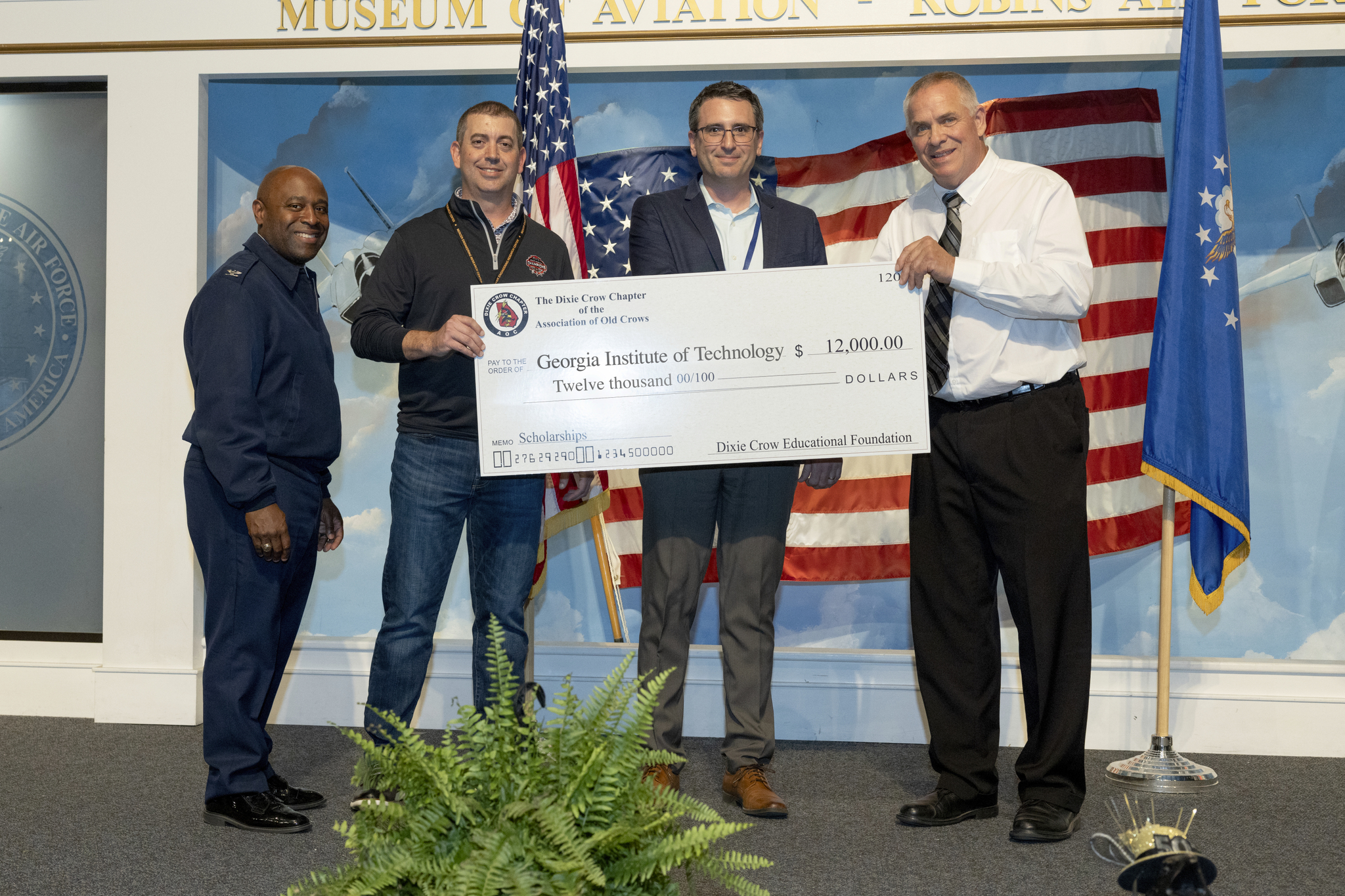 At the Dixie Crow 50th Symposium, Tommer Ender (center) accepts a $12,000 check for scholarships. (Photo Credit: Christopher J. Moore, GTRI)