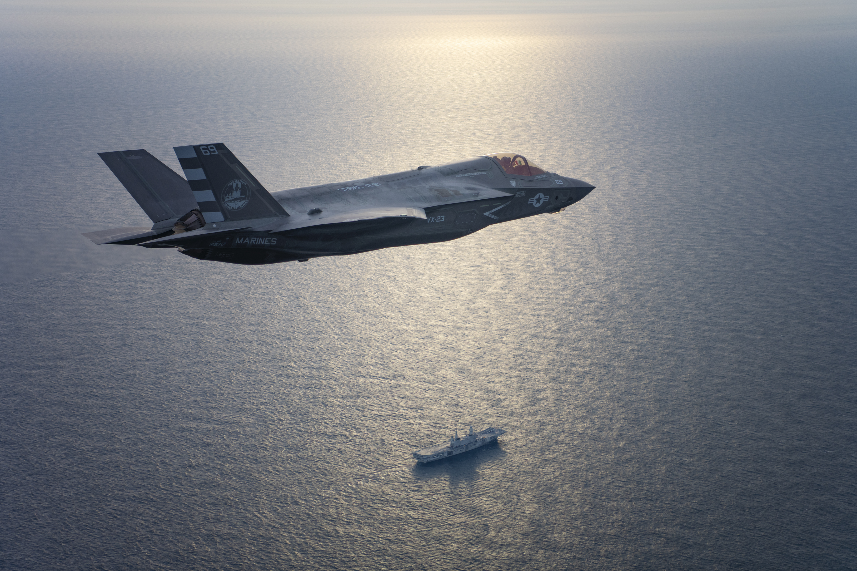 An F-35B flies over an Italian aircraft carrier.