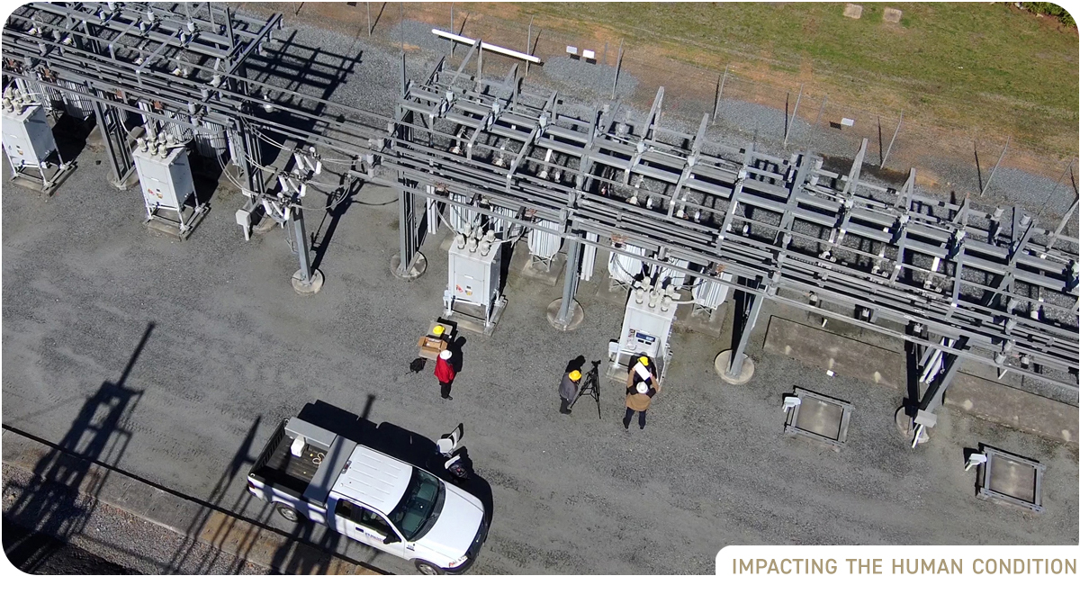 Drone view of power station with workers in hard hats