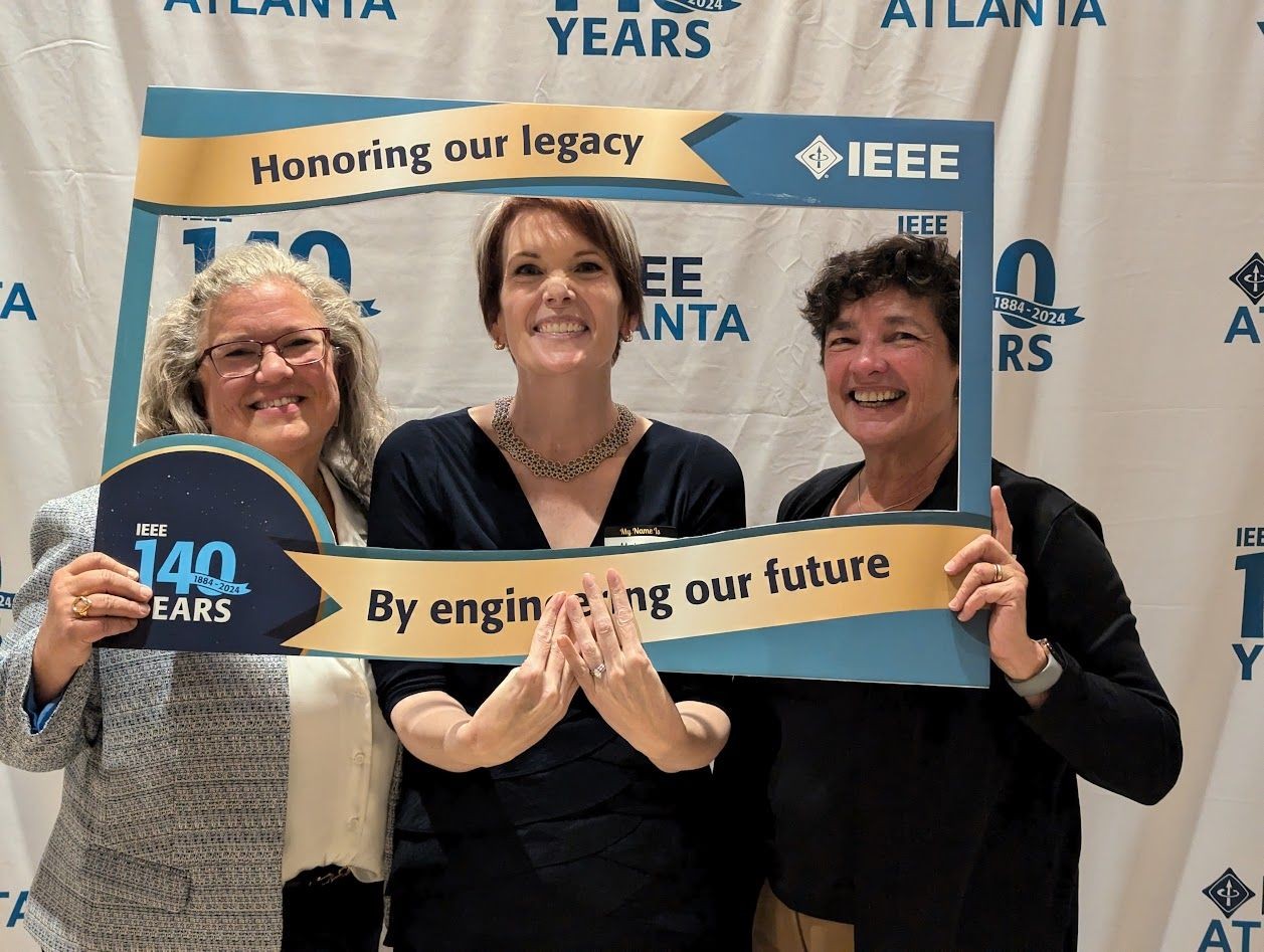 Jill Gostin (left) celebrates the IEEE Atlanta Section's anniversary with IEEE colleagues. (photo credit-Melody Richardson, IEEE)