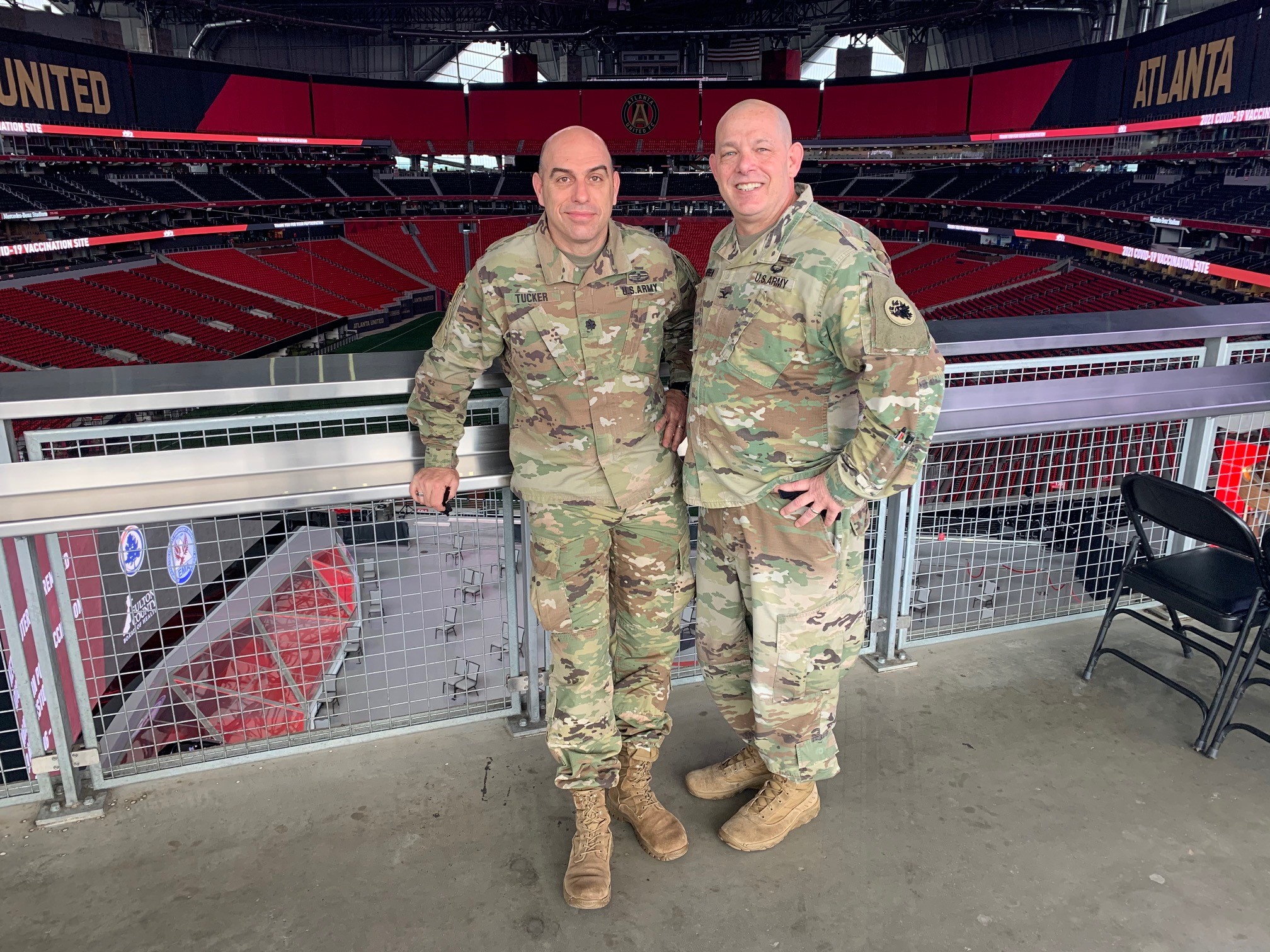 Erik Andersen stands next to a colleague at the Mercedes-Benz Stadium. 