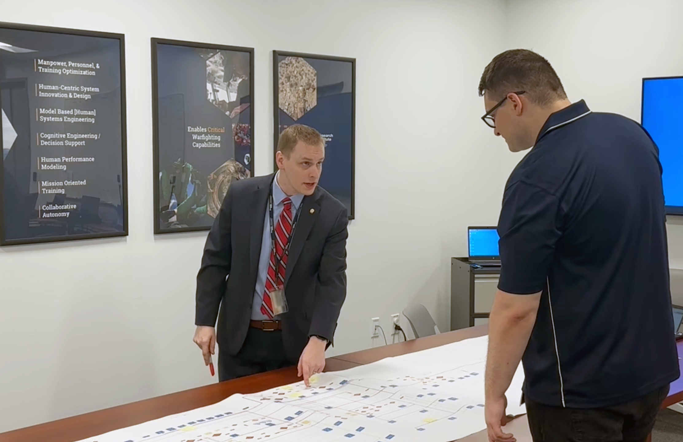 Michelson (left) discusses a graph.