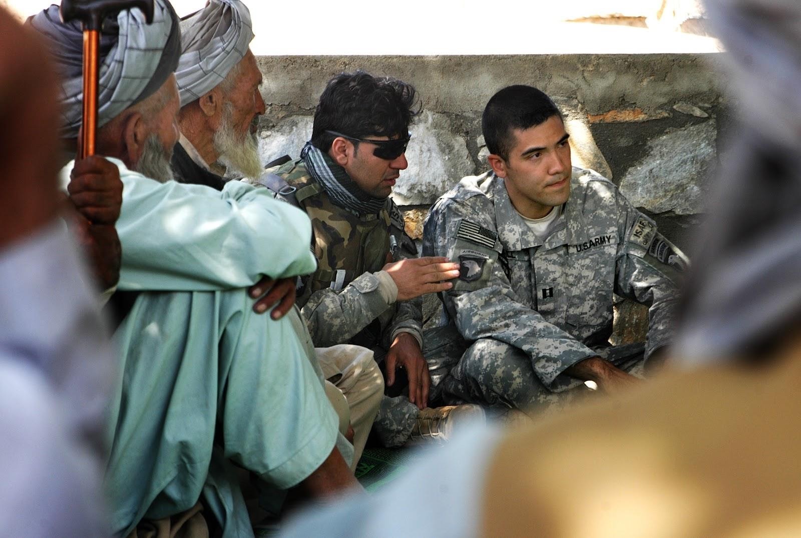 A photo of Roger Hill with his translator at a Jirga meeting 