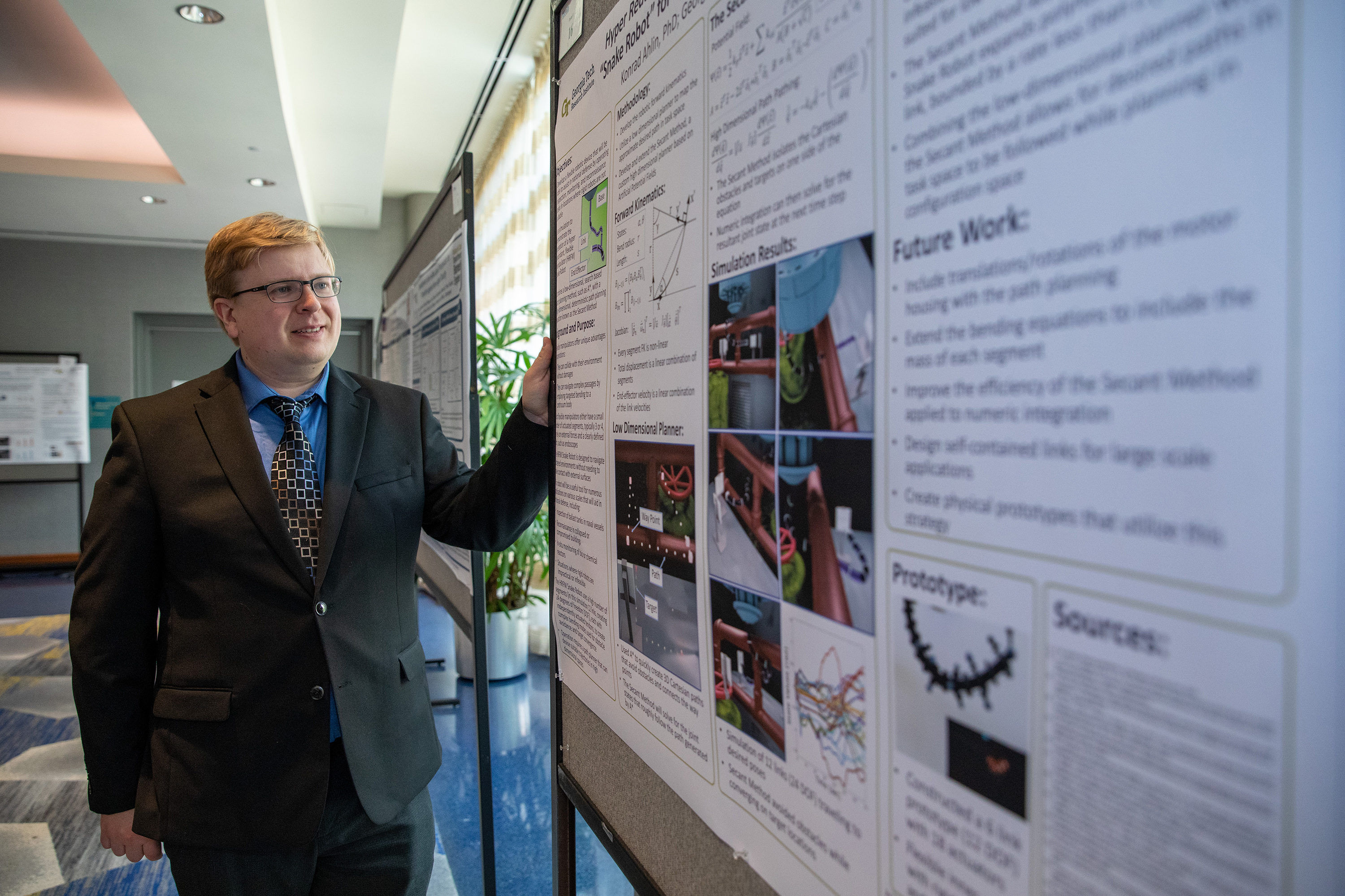 Konrad Ahlin with poster at DARPA Forward meeting