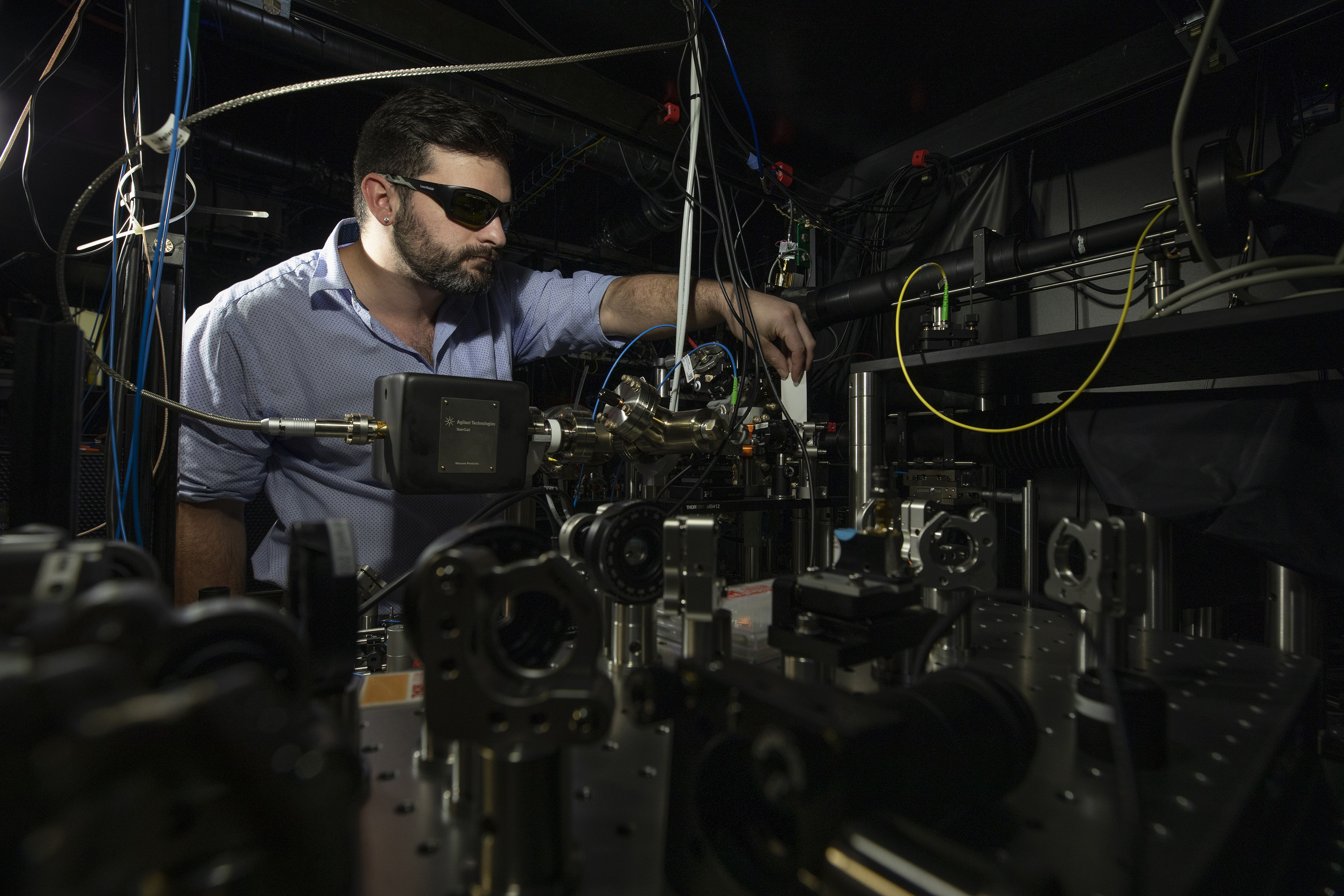 Researcher checks alignment of Doppler cooling beam