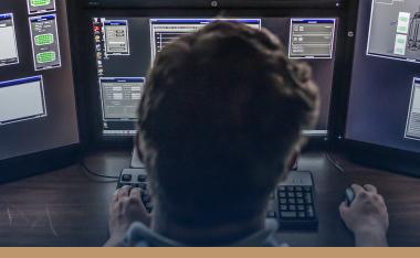 GTRI employee in front of monitors