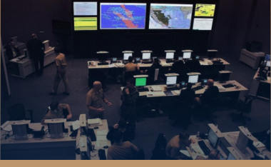 large command center with people and monitors