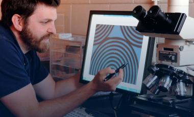 researcher shows an optical microscope image 