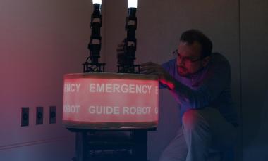 GTRI Research Engineer Paul Robinette adjusts the arms of the “Rescue Robot.” (Credit: Rob Felt, Georgia Tech)