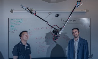 Researchers Jonathan Rogers and Ai-Ping Hu are shown with the Tarzan robot in a Georgia Tech lab