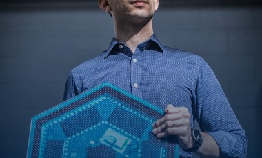 Ilan Stern, a GTRI senior research scientist, holds examples of the electronic components that will be used in piezoelectric tiles that will be used to create a lighted outdoor footpath at the NASA Kennedy Space Center’s Visitor Complex at Cape Canaveral, Florida. The tiles are powered by piezoelectric components that generate current when they are compressed, flexed or vibrated. (Credit: Branden Camp, Georgia Tech Research Institute)
