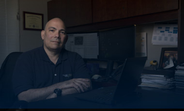 1)	Carlos Davila, chief engineer, Intelligence, Surveillance and Reconnaissance Division (ISRD) Sensors and Electromagnetic Applications Laboratory (SEAL) at GTRI, sits in his office. (Photo credit: Sean McNeil)