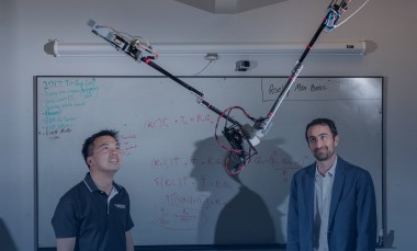 Researchers Jonathan Rogers and Ai-Ping Hu are shown with the Tarzan robot in Georgia Tech Research Institute Lab