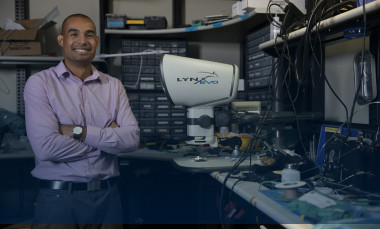 Mike Ruiz, a GTRI principal research engineer, stands in at a workspace. (Photo credit: Sean McNeil)