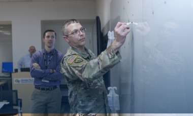 Participants of the Georgia Army Nation Guard working group brainstorm ideas on the whiteboard. (Credit: Christopher Moore)
