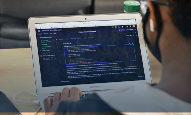 A student works on his laptop. 