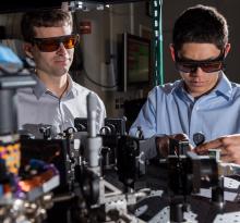 GTRI scientists work in an optical lab developing improved ion traps that could be used in quantum computing. Shown, from left, are research scientists Jason Amini and Nicholas Guise. (Credit: Rob Felt)