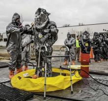 two people in chemical suits