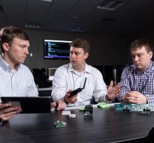three researchers with internet of things devices
