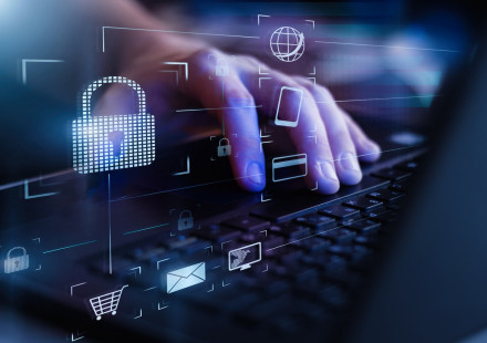 Closeup view of man`s hand using laptop with virtual digital screen with icon of lock on it. (Credit: Traitov, iStockphoto.com)