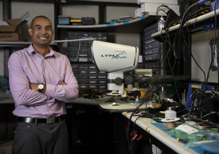 Mike Ruiz, a GTRI principal research engineer, stands in at a workspace. (Photo credit: Sean McNeil)