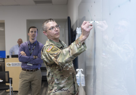 Participants of the Georgia Army Nation Guard working group brainstorm ideas on the whiteboard. (Credit: Christopher Moore)