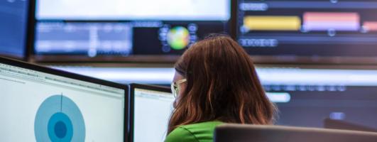 GTRI employee in front of monitors