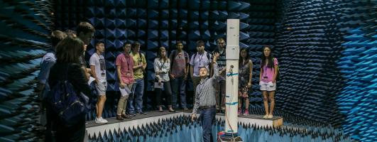 Students receiving instruction from teacher inside anechoic chamber