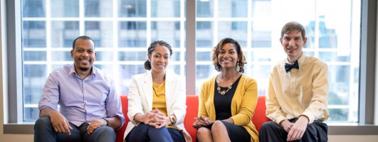 Four GTRI team members sitting on a couch
