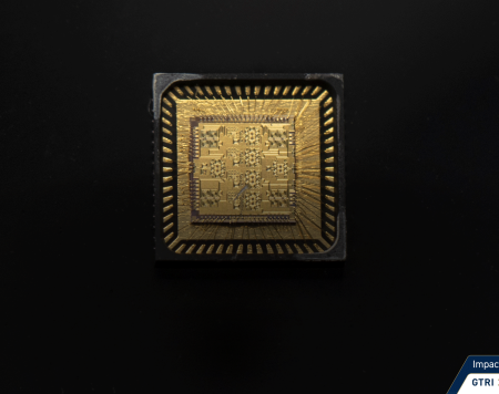 Gold microchip on black background.