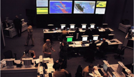 large command center with people and monitors