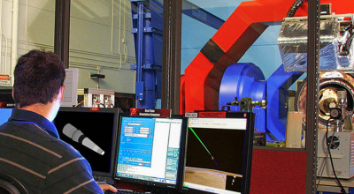 Two researchers in front of large machine