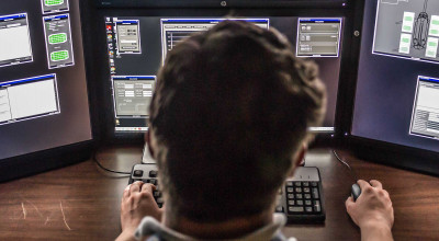 GTRI employee in front of monitors