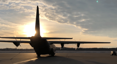 photo - C130J aircraft on the ground in silhouette with sunset