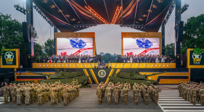 Official Army 250th anniversary "reenlistment. Two columns of soldiers saluting