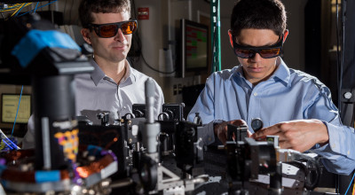 GTRI scientists work in an optical lab developing improved ion traps that could be used in quantum computing. Shown, from left, are research scientists Jason Amini and Nicholas Guise. (Credit: Rob Felt)