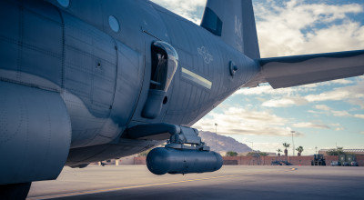 Using an articulated arm called the SABIR AS-7 STRUT, Northrop Grumman’s LITENING targeting pod can be mounted onto the paratroop door of an HC-130J. (Photo credit: Taylor Cifuentes)